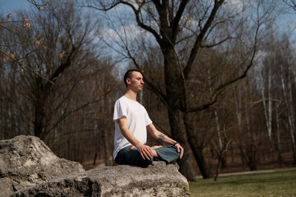 Man practicing yoga outdoors
