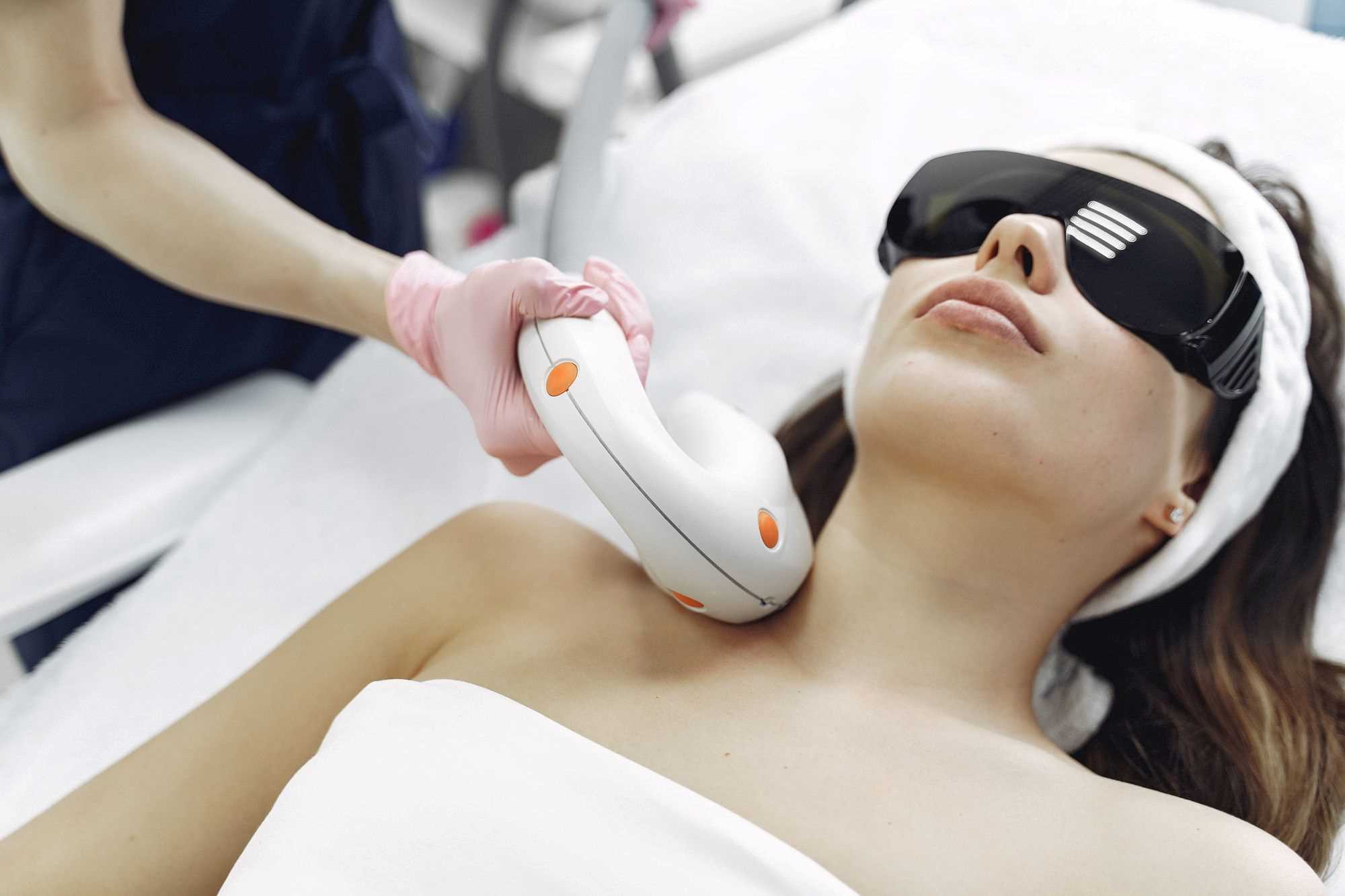Woman undergoing laser treatment to achieve youthful skin