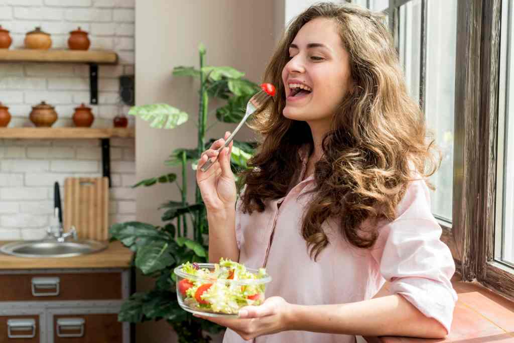 Woman eating balanced diet to achieve healthy skin