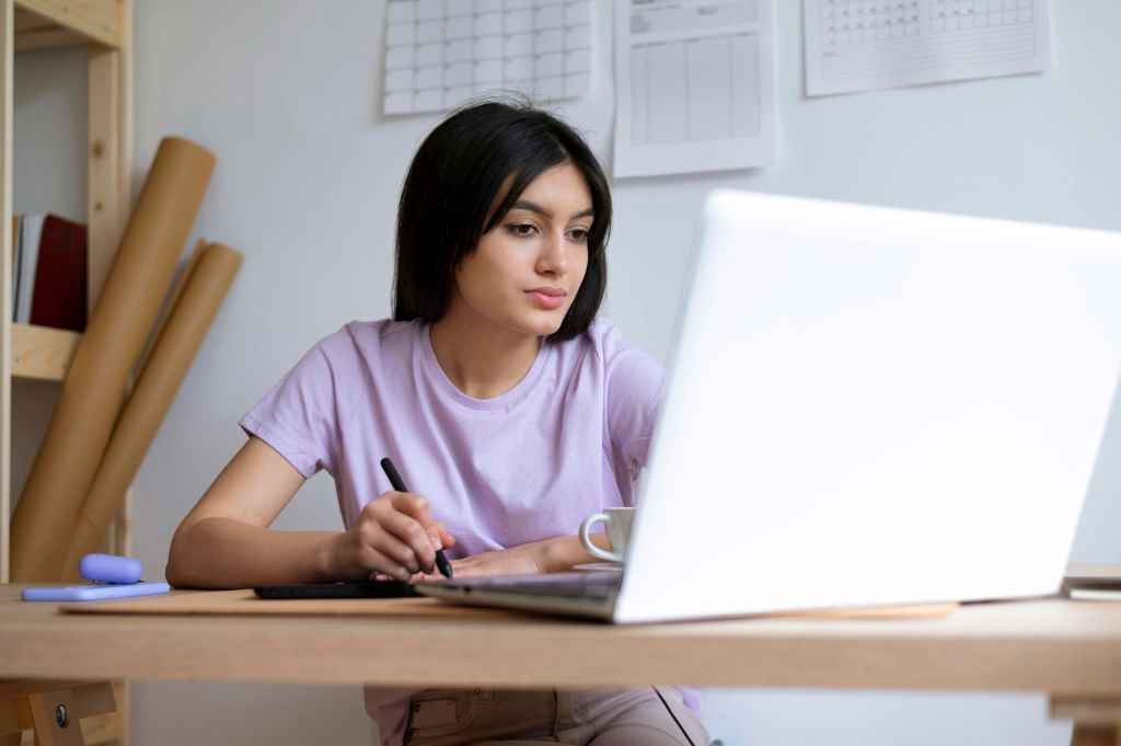 A girl making portfolio on laptop