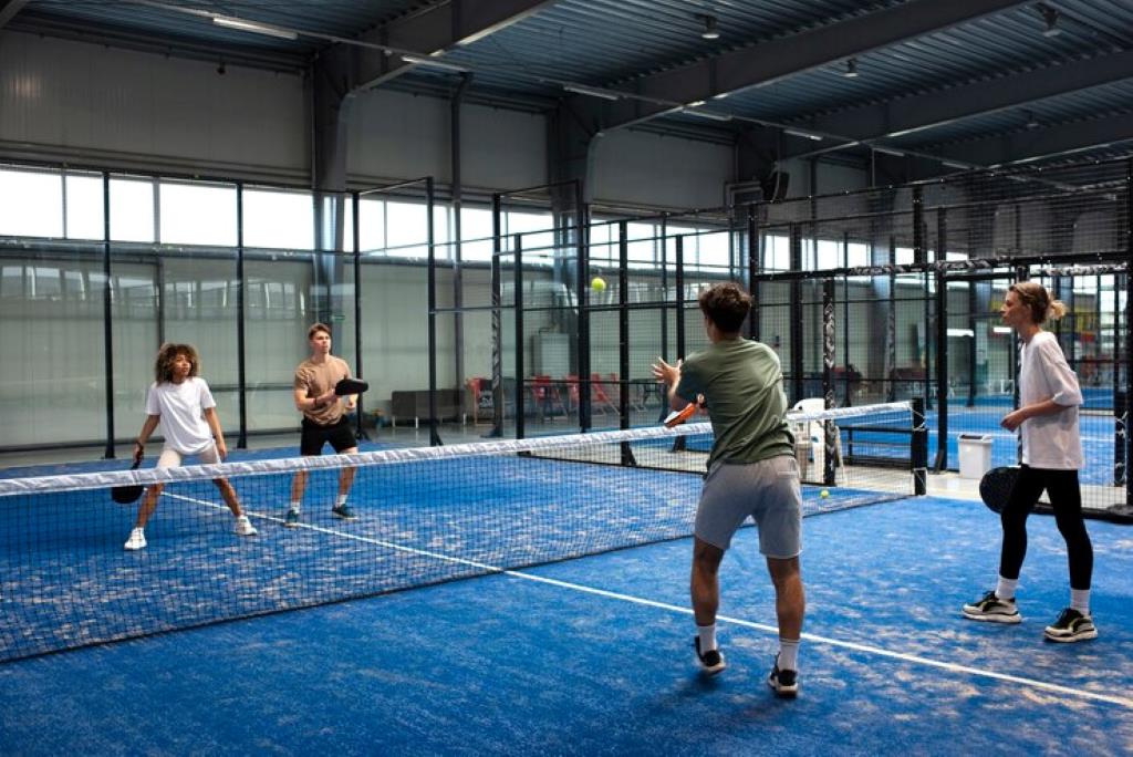People playing padle tennis inside